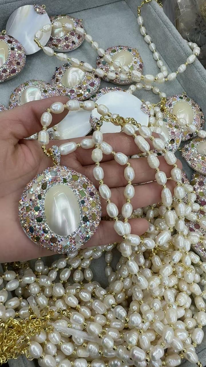 A luxurious necklace crafted from natural freshwater pearls with a stunning mother-of-pearl centerpiece.